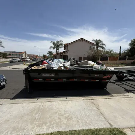Residential dumpster filled with debris